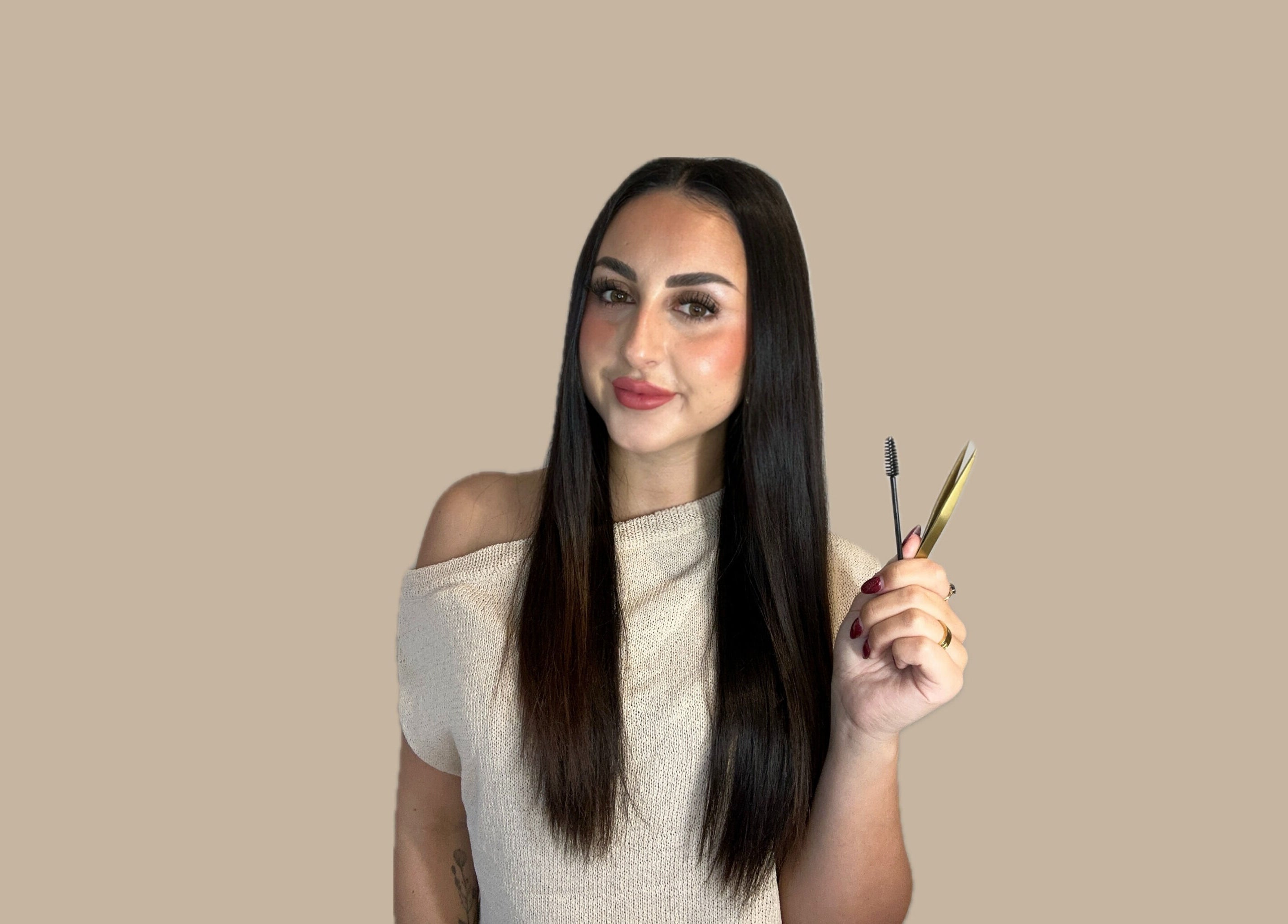 Makeup artist at Aesthetics By Hailee in Red Beach, Auckland, NZ holding beauty tools with confidence.