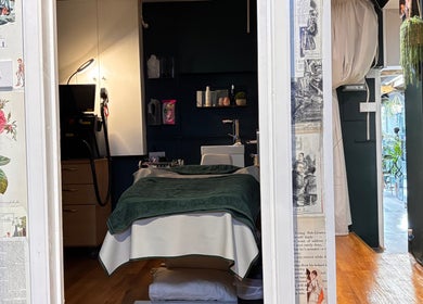 Cozy treatment room at Spoilt Beauty in Coggeshall Essex, featuring a massage bed and soft lighting.