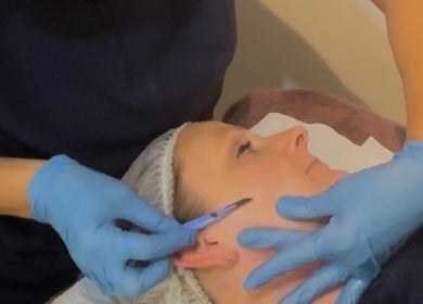 Facial treatment at Spoilt Beauty in Coggeshall Essex, Coggeshall, England, GB with gloves and precision tool.
