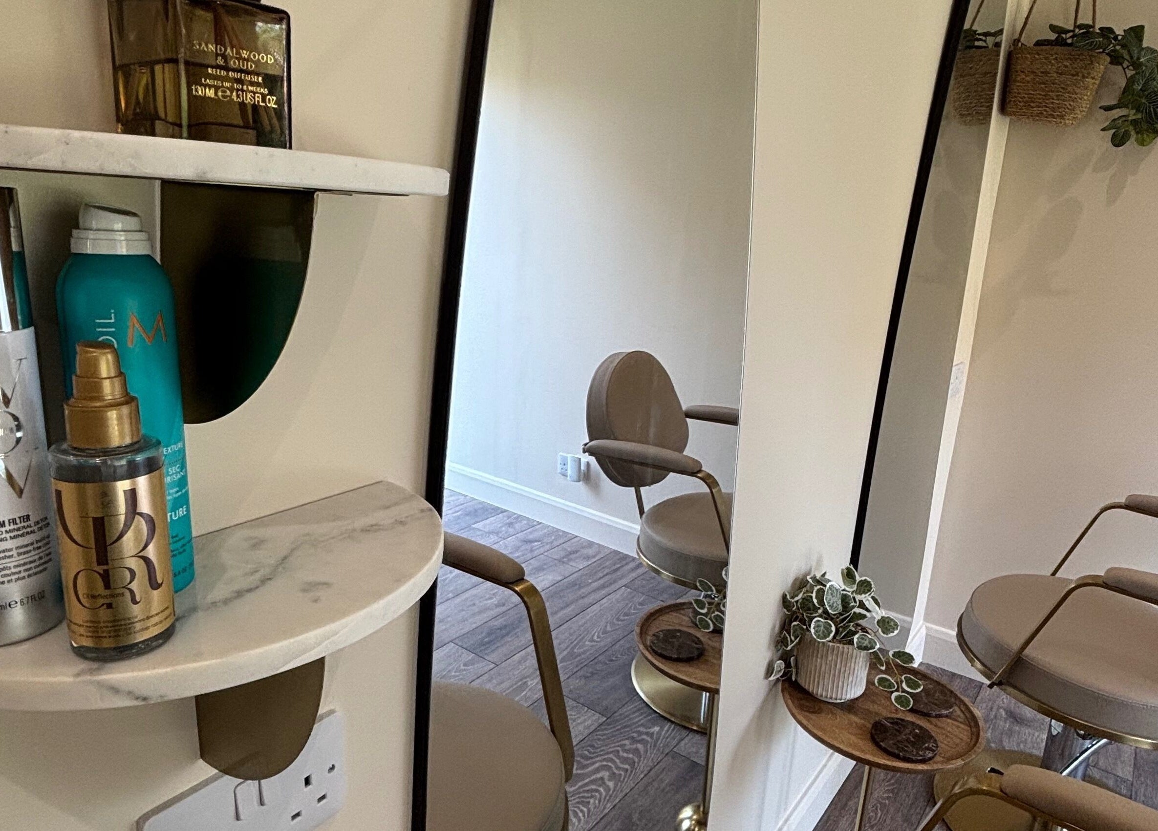 Sophisticated styling station at Studio G., Gateshead, England, GB featuring modern chairs and luxury products.