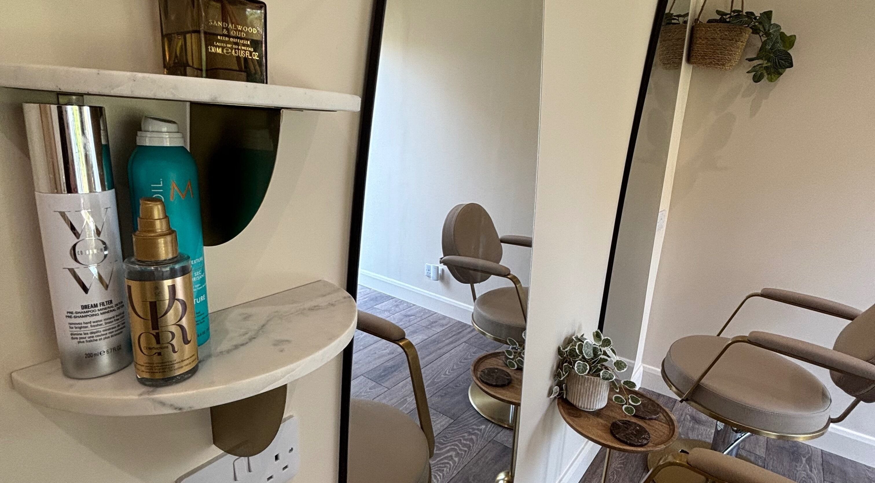 Sophisticated styling station at Studio G., Gateshead, England, GB featuring modern chairs and luxury products.