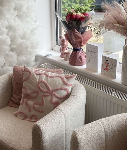 Inviting lounge area at Beauty by Ella Neal, Burnley, England, GB. Features plush chairs and decor.