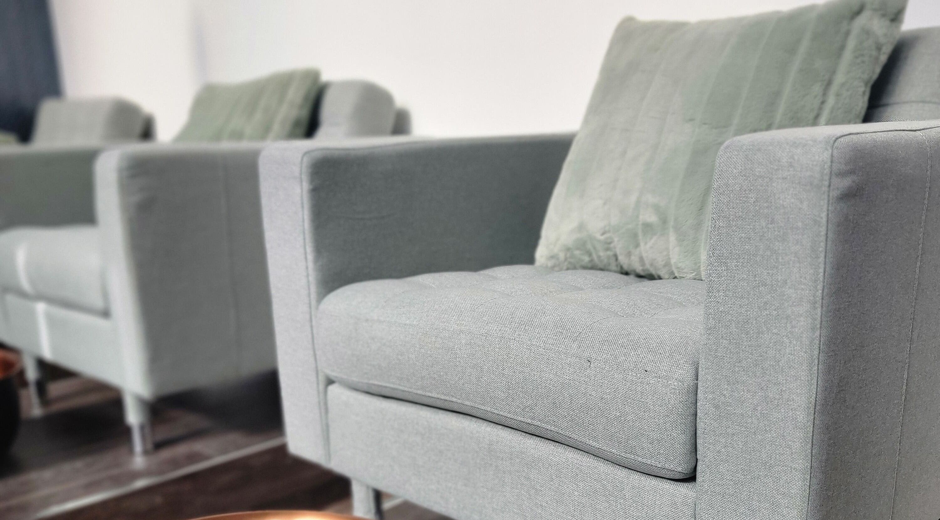 Stylish grey seating at Formation Beauty Lounge, Vancouver, British Columbia, CA, enhancing relaxation ambiance.