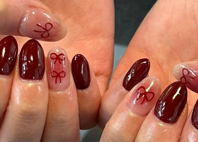Elegant nail art with red ribbons at Formation Beauty Lounge, Vancouver, British Columbia, CA.