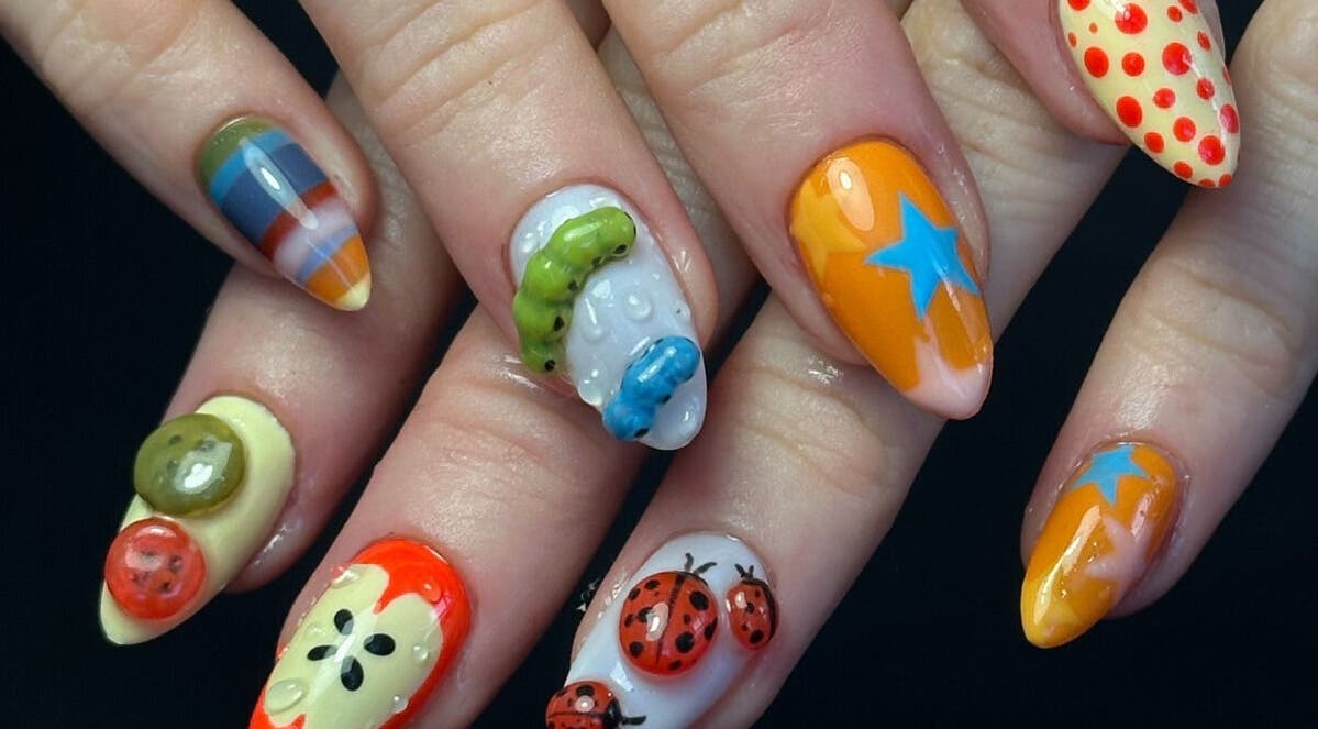 Artistic nail designs featuring vibrant patterns at Fampy Nails, Montréal, Québec, CA.