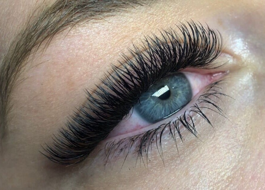 Close-up of expertly applied eyelash extensions at The Eye Studio, Auckland, Auckland, NZ, enhancing a blue eye.