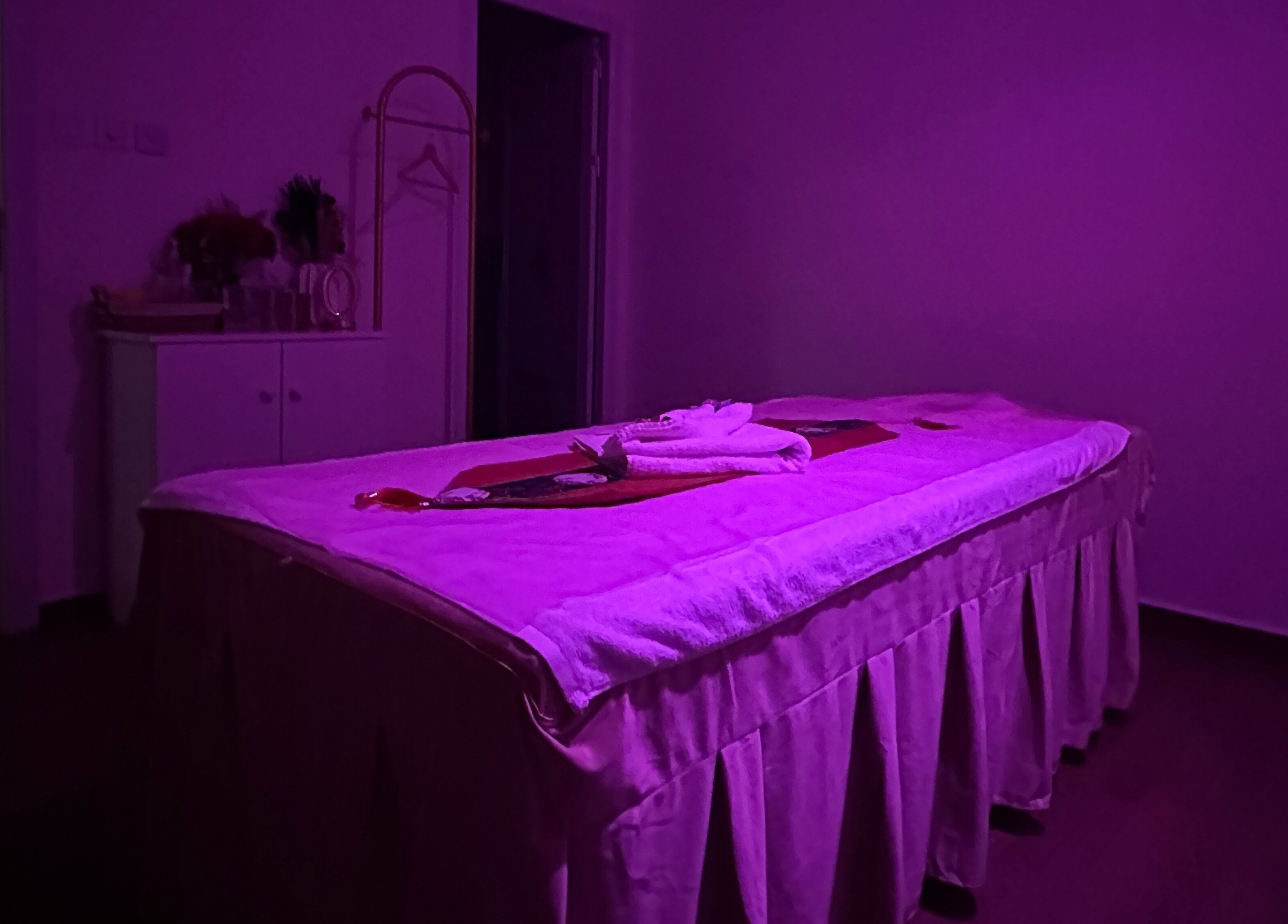 Relax in the serene purple-lit massage room at L and Y Salon and SPA for Man - Musaffah Massage, Abu Dhabi, AE.