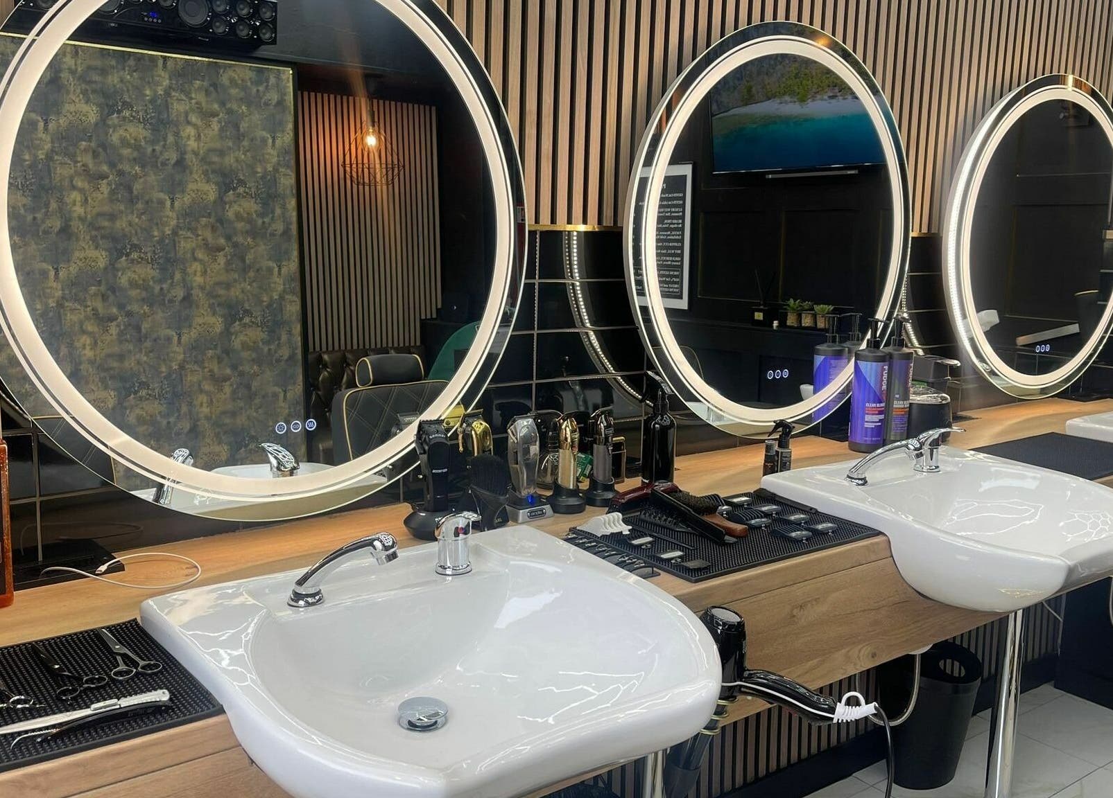 Modern styling area with illuminated mirrors at Chopafellas, Wickford, England, GB.