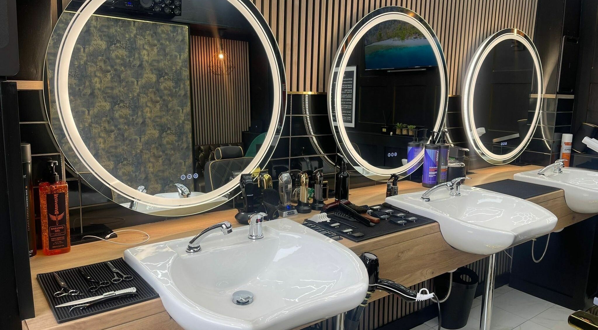Modern styling area with illuminated mirrors at Chopafellas, Wickford, England, GB.