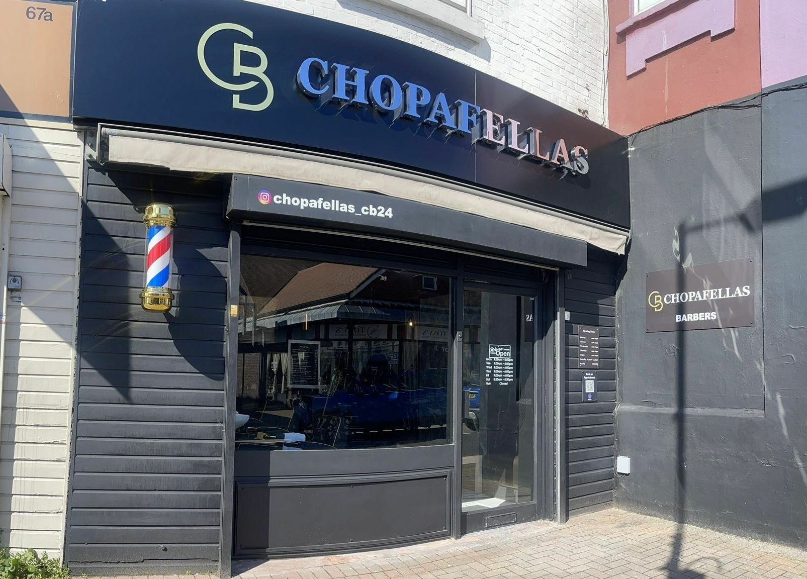 Front view of Chopafellas barbershop in Wickford, England, GB with a traditional barber pole.