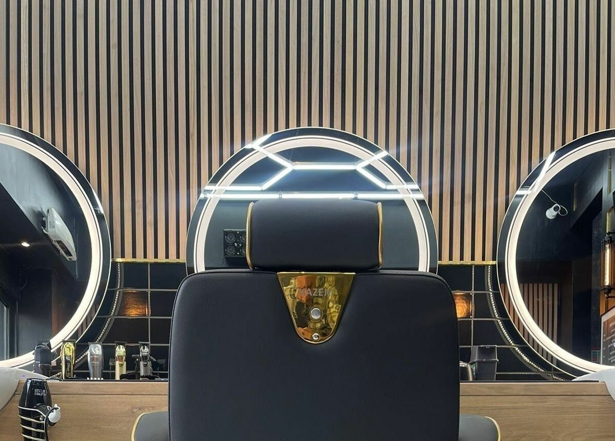 Luxury barber chair and modern mirrors at Chopafellas, Wickford, England, GB highlighting sleek interior design.