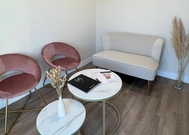 Oasis Aesthetics Spa - Ness in Winnipeg, Manitoba, CA. Chic waiting area with plush seating and modern decor.