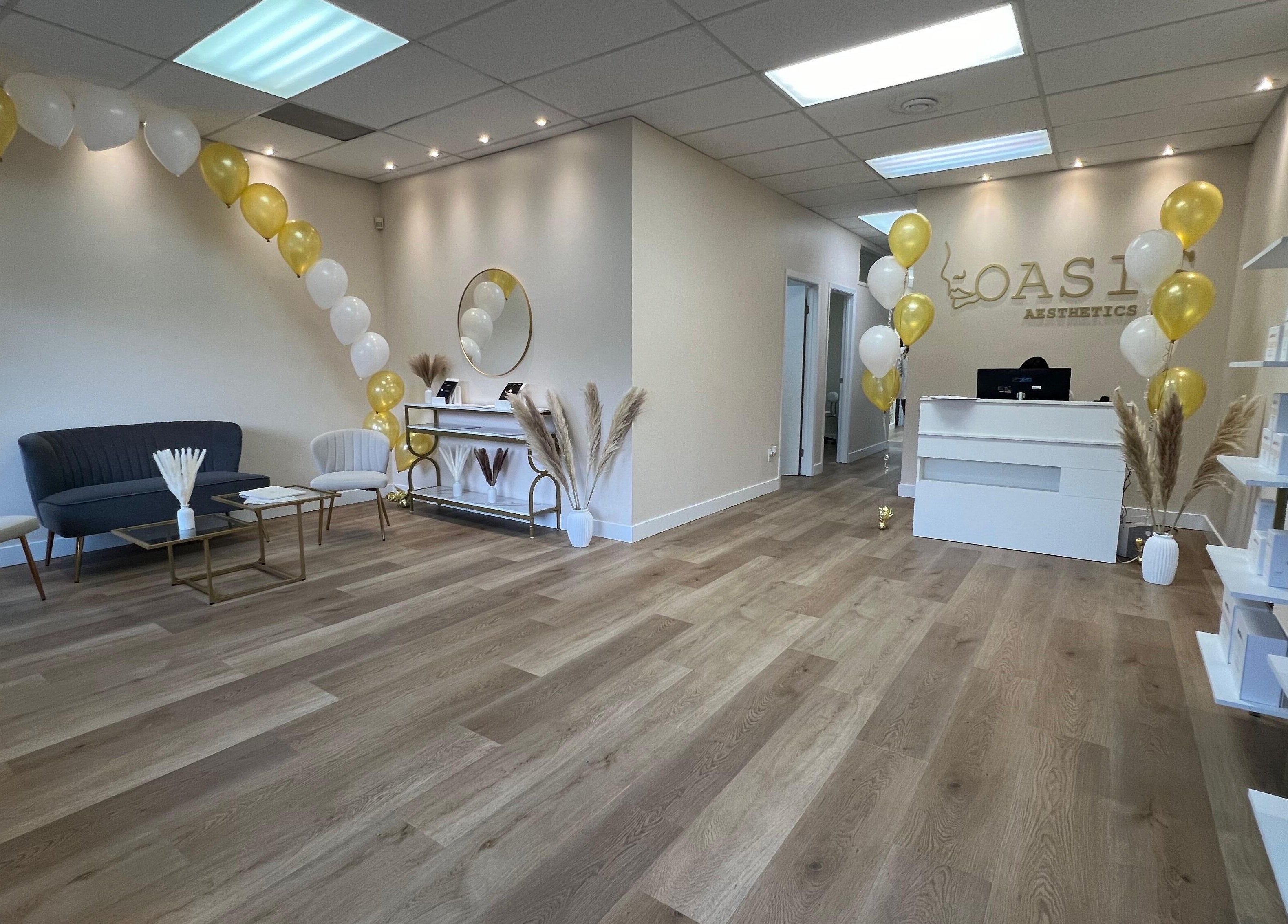 Reception area of Oasis Aesthetics Spa - Henderson, Winnipeg, Manitoba, CA with elegant decor and balloons.