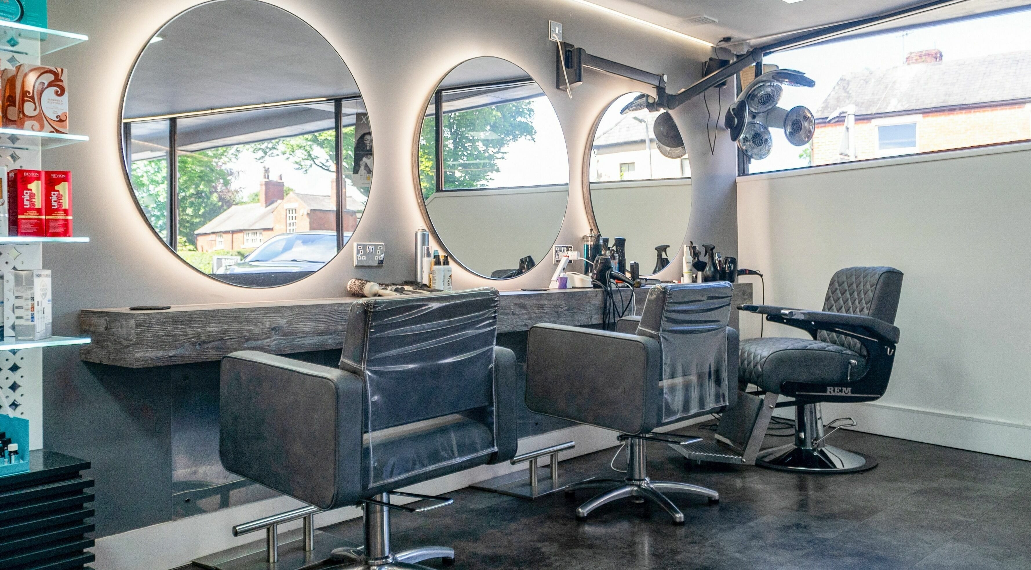 Modern interior of J and K Hair salon in Longton, England, GB featuring stylish chairs and mirrors.