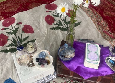 Spiritual setup at Indigo Wellness, Falmouth, England, GB features crystals, tarot cards, and candles.
