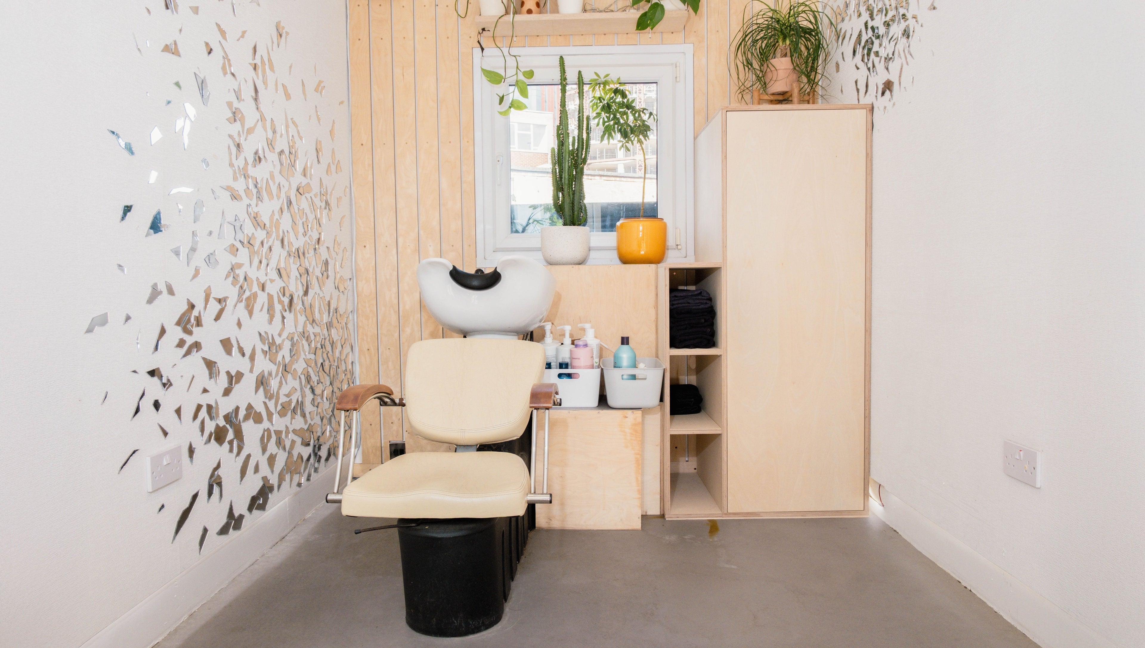 Modern salon corner at Klip London, London, England, GB with stylish wall decor and cozy seating.