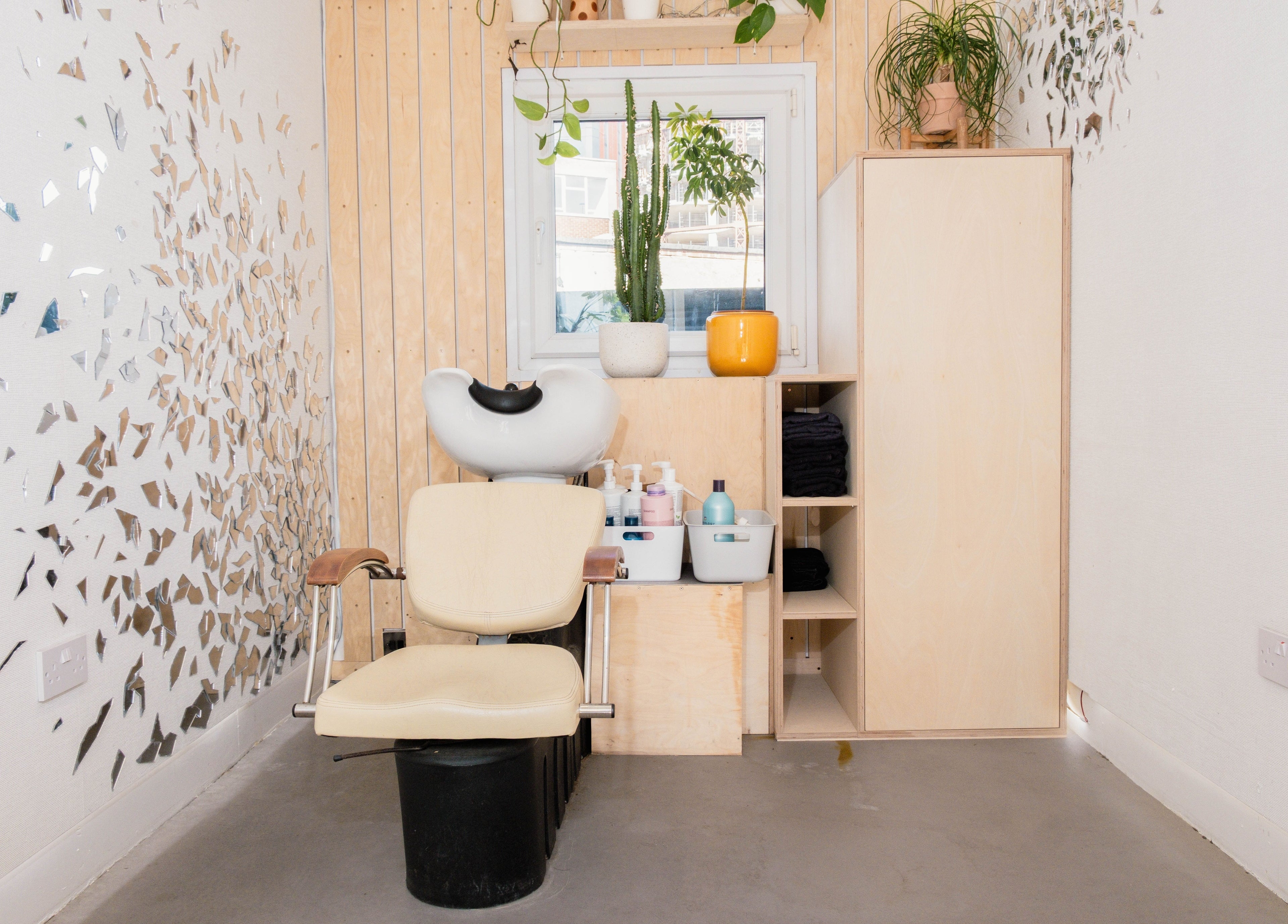 Modern salon corner at Klip London, London, England, GB with stylish wall decor and cozy seating.
