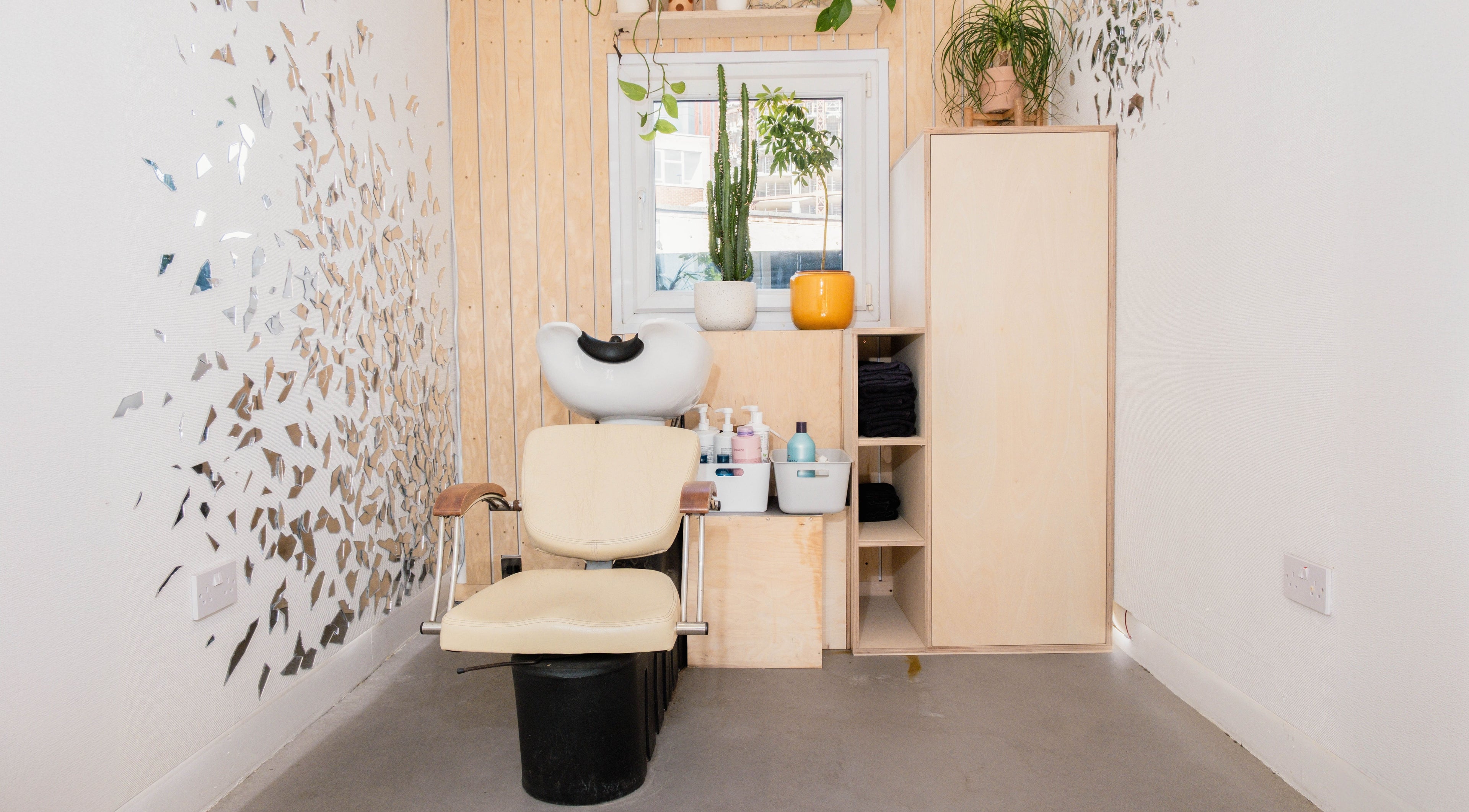 Modern salon corner at Klip London, London, England, GB with stylish wall decor and cozy seating.