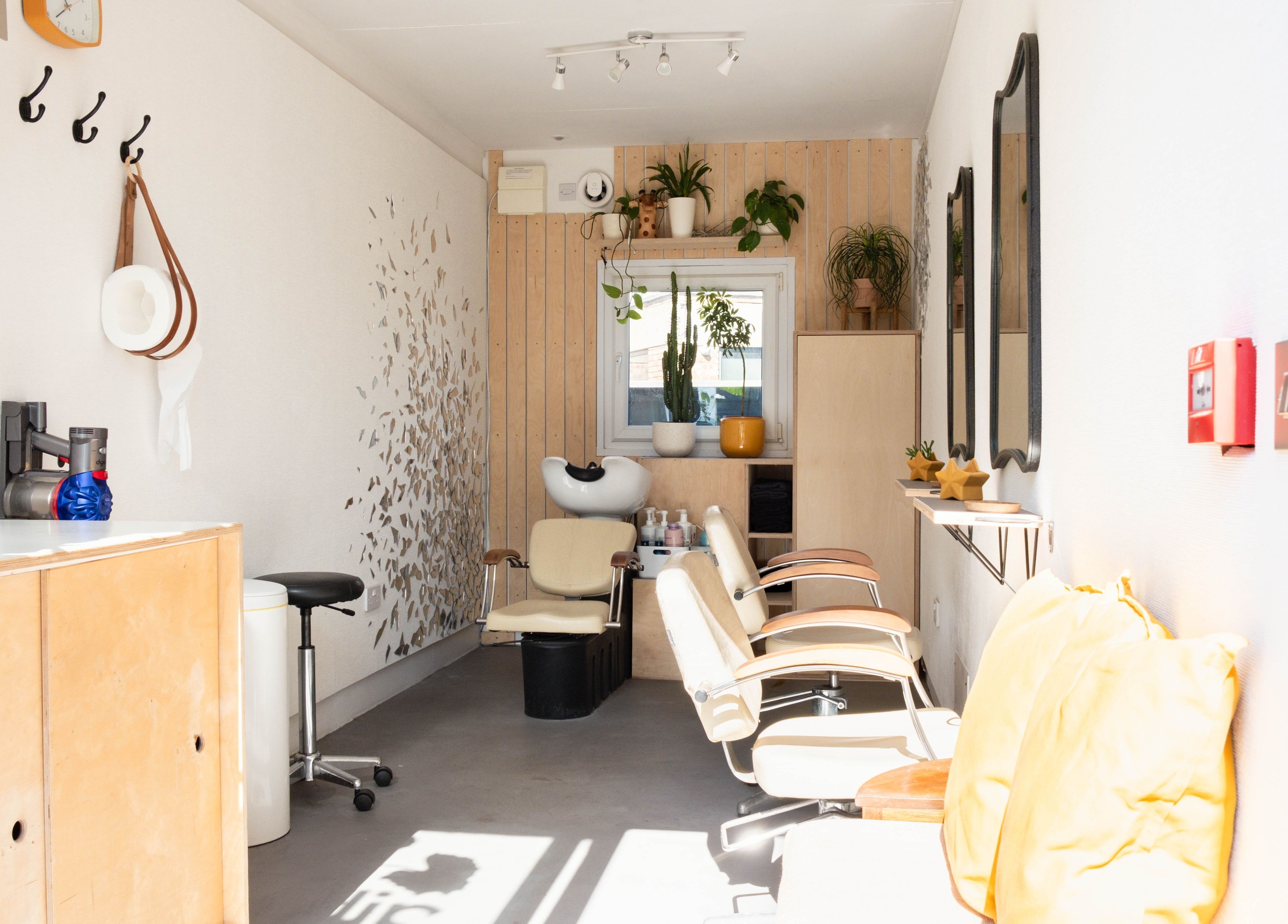 Klip London salon in London, England, GB, showcasing chic interior with elegant styling chairs and plant décor.