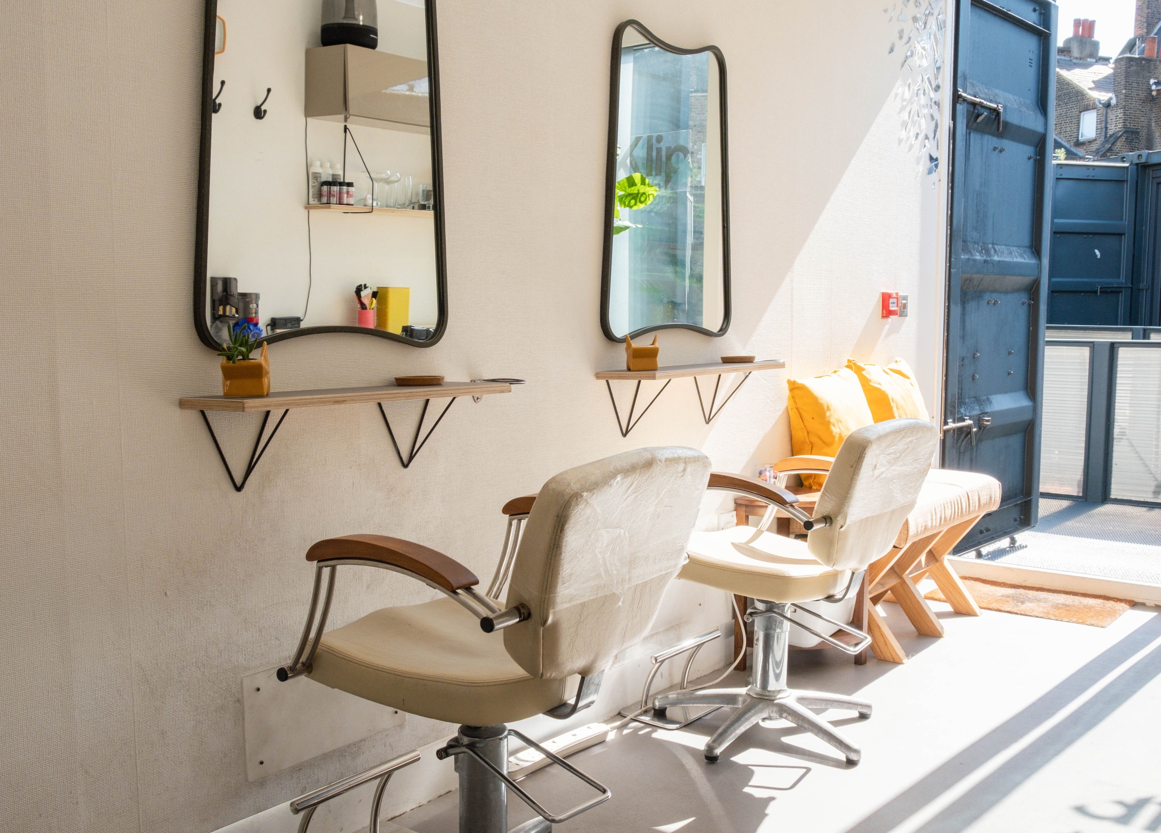 Bright, stylish salon chairs and mirrors at Klip London, London, England, GB.