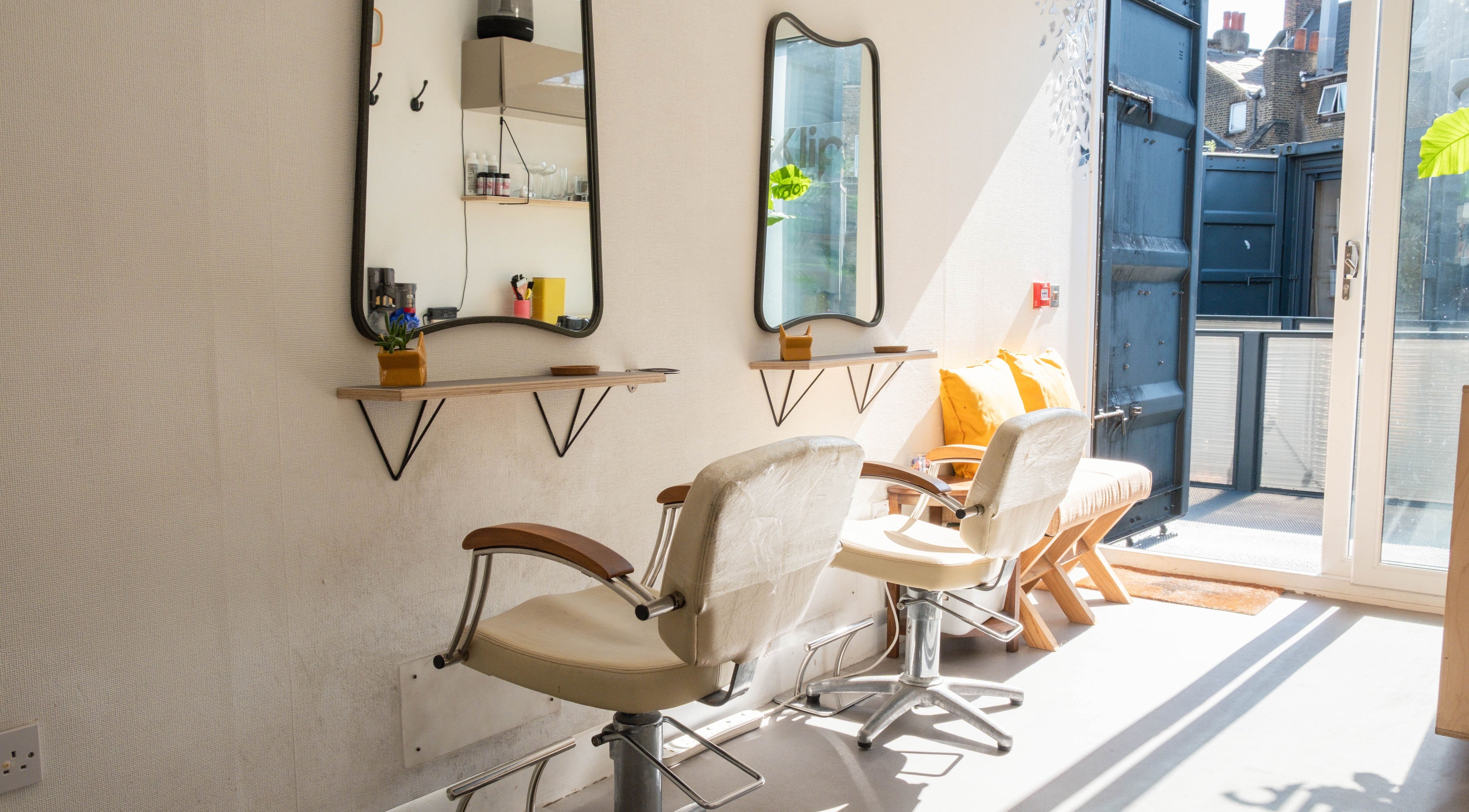 Bright, stylish salon chairs and mirrors at Klip London, London, England, GB.