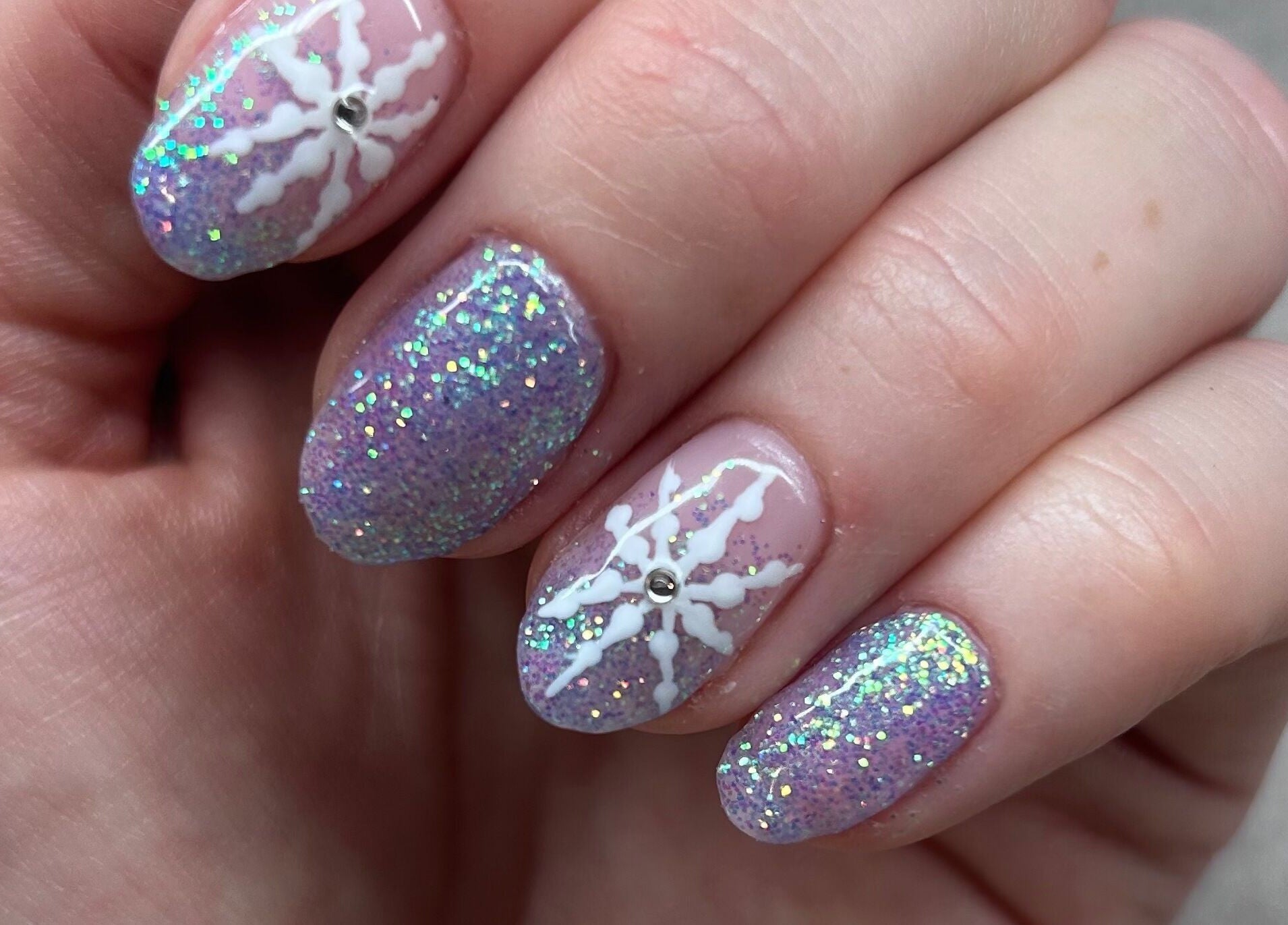 Manicured nails with glitter and star design at Bellisamani, Rickmansworth, England, GB.