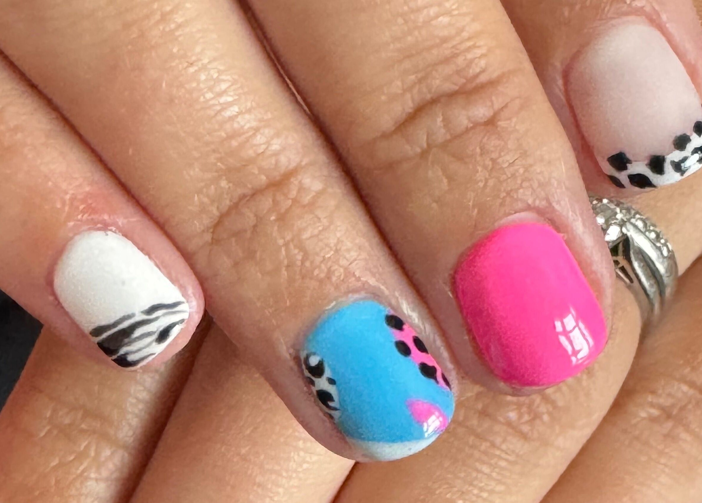 Colorful nail art with leopard accents at Bellisamani, Rickmansworth, England, GB.