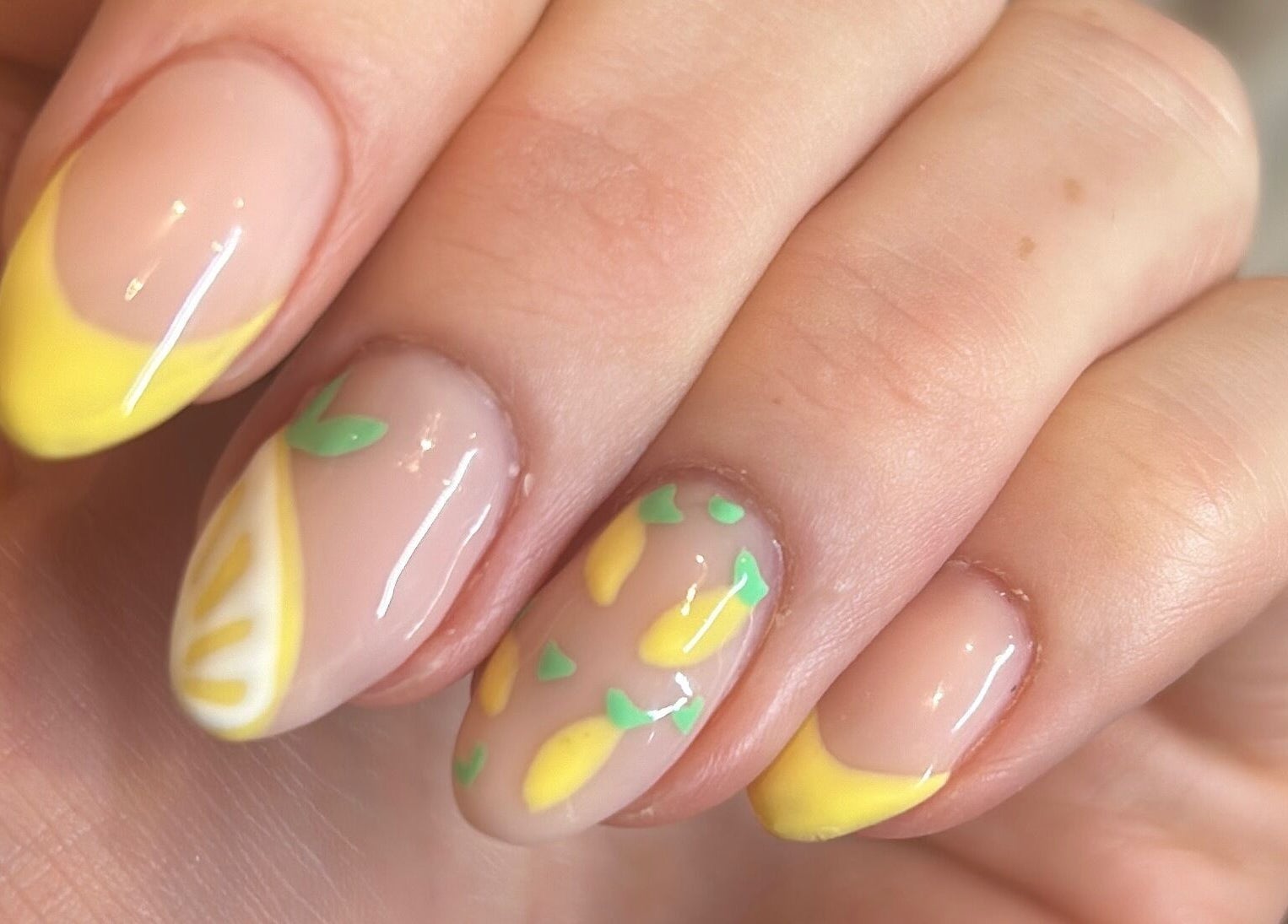 Lemon-inspired nail art at Bellisamani, Rickmansworth, England, GB, showcasing vibrant yellow and green designs.