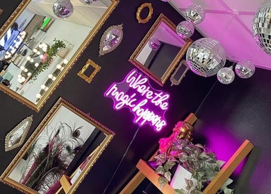Chic interior with mirrors and neon sign at Hair By Phoebe, Epworth, England, GB.