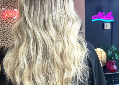 Blonde waves styled at Hair By Phoebe in Epworth, England, GB. Vibrant salon backdrop enhances the chic hairstyle.