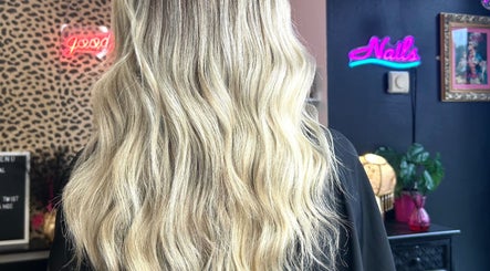 Blonde waves styled at Hair By Phoebe in Epworth, England, GB. Vibrant salon backdrop enhances the chic hairstyle.