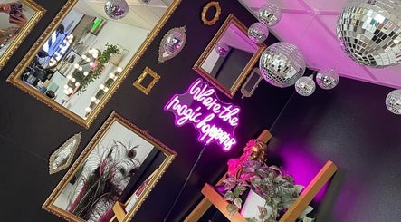 Stylish salon mirrors and neon sign at Hair By Phoebe in Epworth, England, GB, creating a chic atmosphere.