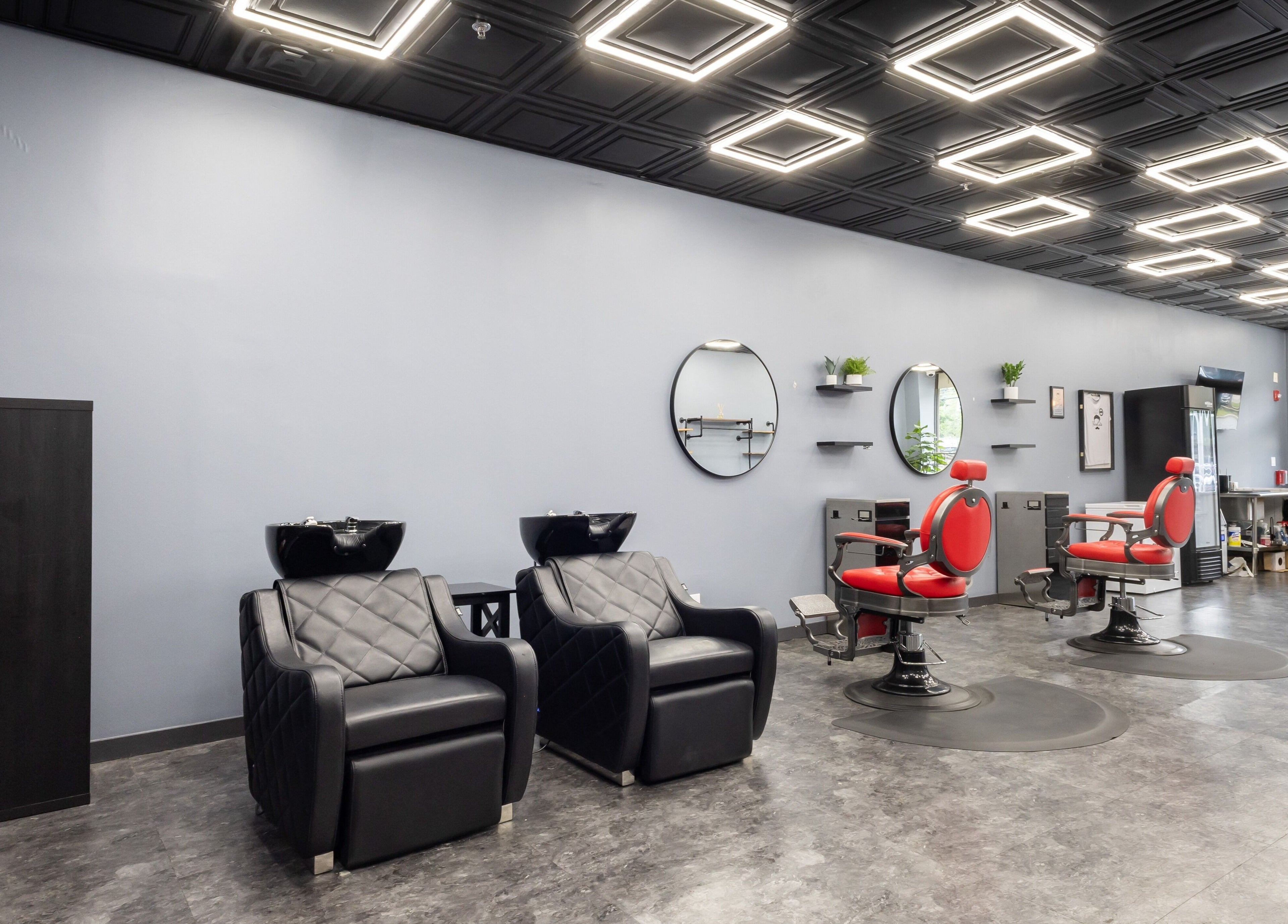 Modern interior of YuroCuts Garnerville with black and red chairs in Mount Ivy, New York, US.