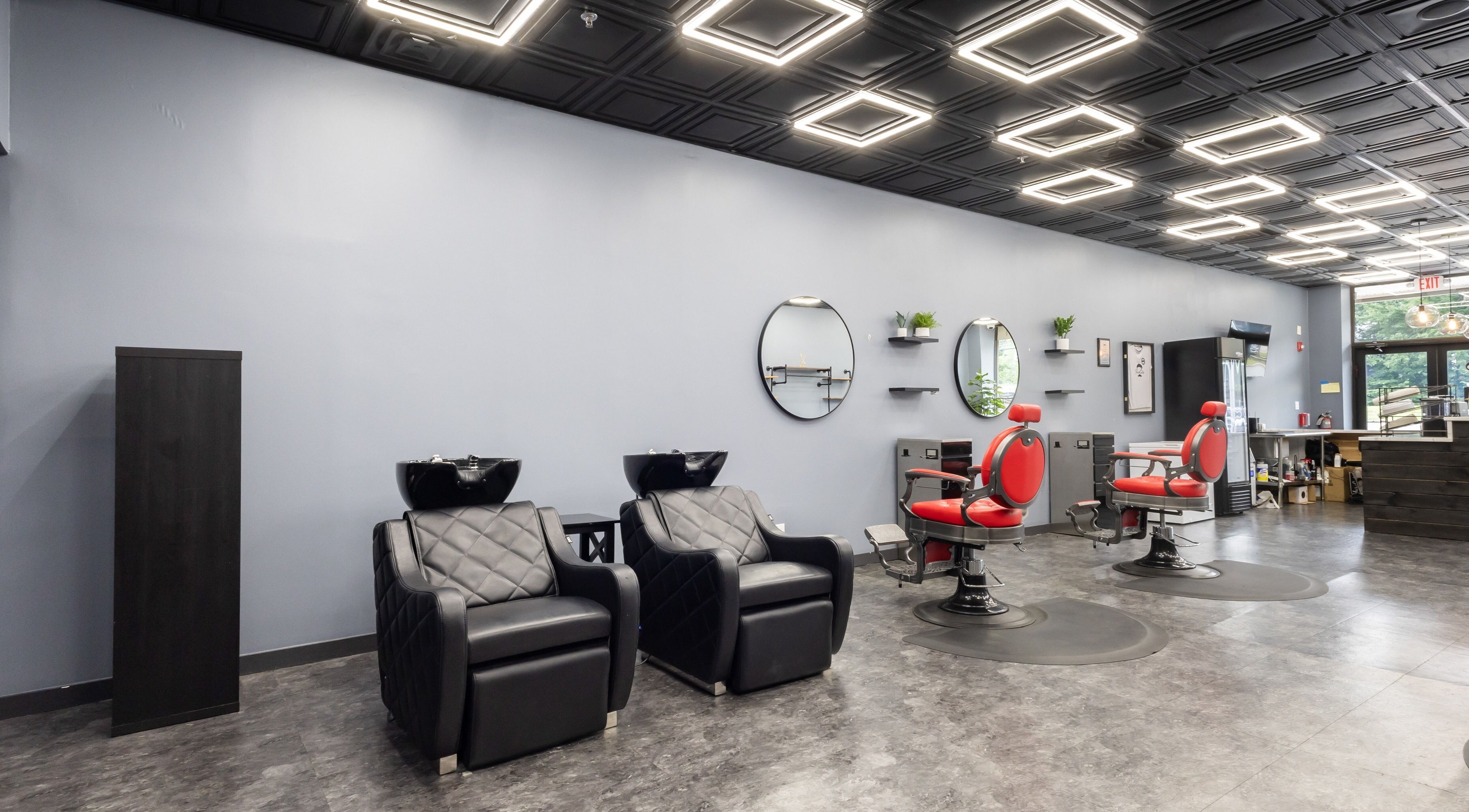 Modern interior of YuroCuts Garnerville with black and red chairs in Mount Ivy, New York, US.