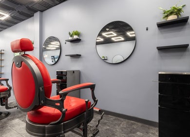 Modern red salon chairs and mirrors at YuroCuts Garnerville, Mount Ivy, New York, US.