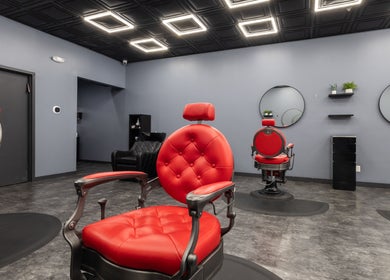Modern red chairs in YuroCuts Garnerville salon, Mount Ivy, New York, US, creating a sleek ambiance.