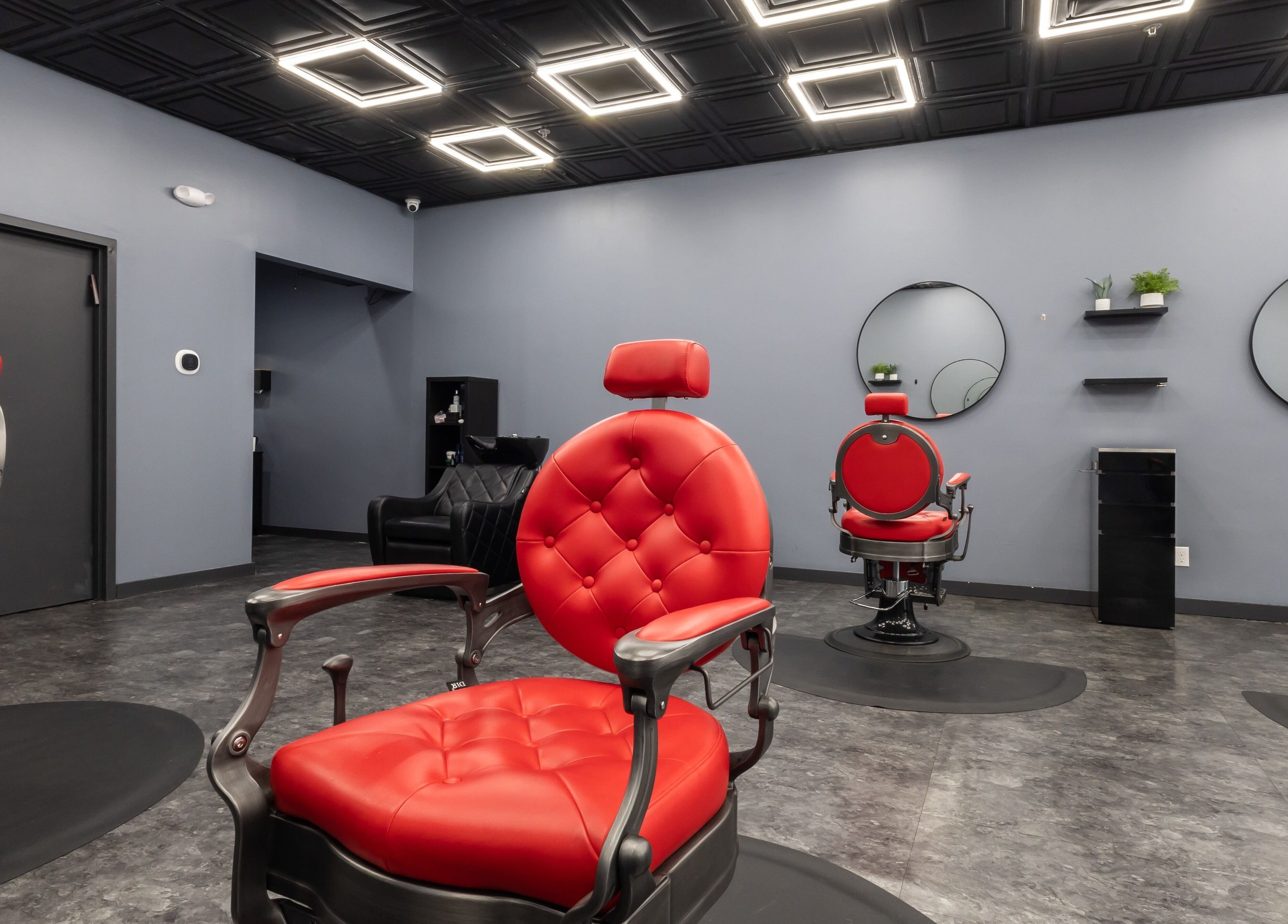 Modern red chairs in YuroCuts Garnerville salon, Mount Ivy, New York, US, creating a sleek ambiance.