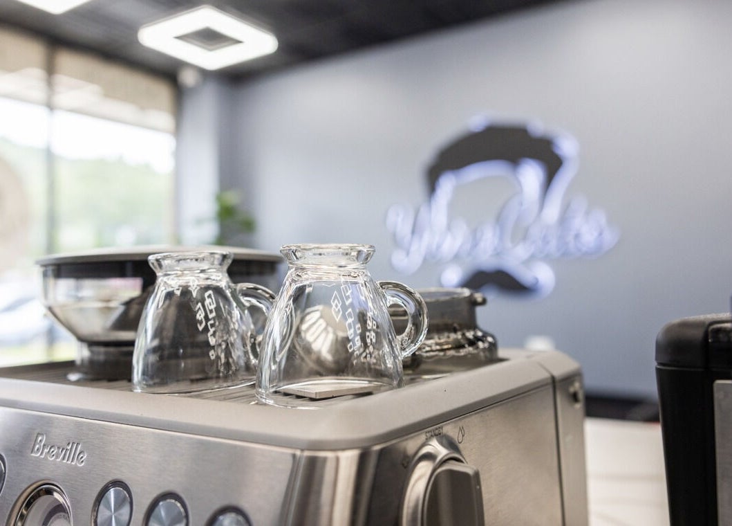 Coffee machine with glass cups at YuroCuts Garnerville, Mount Ivy, New York, US enhancing visitor experience.