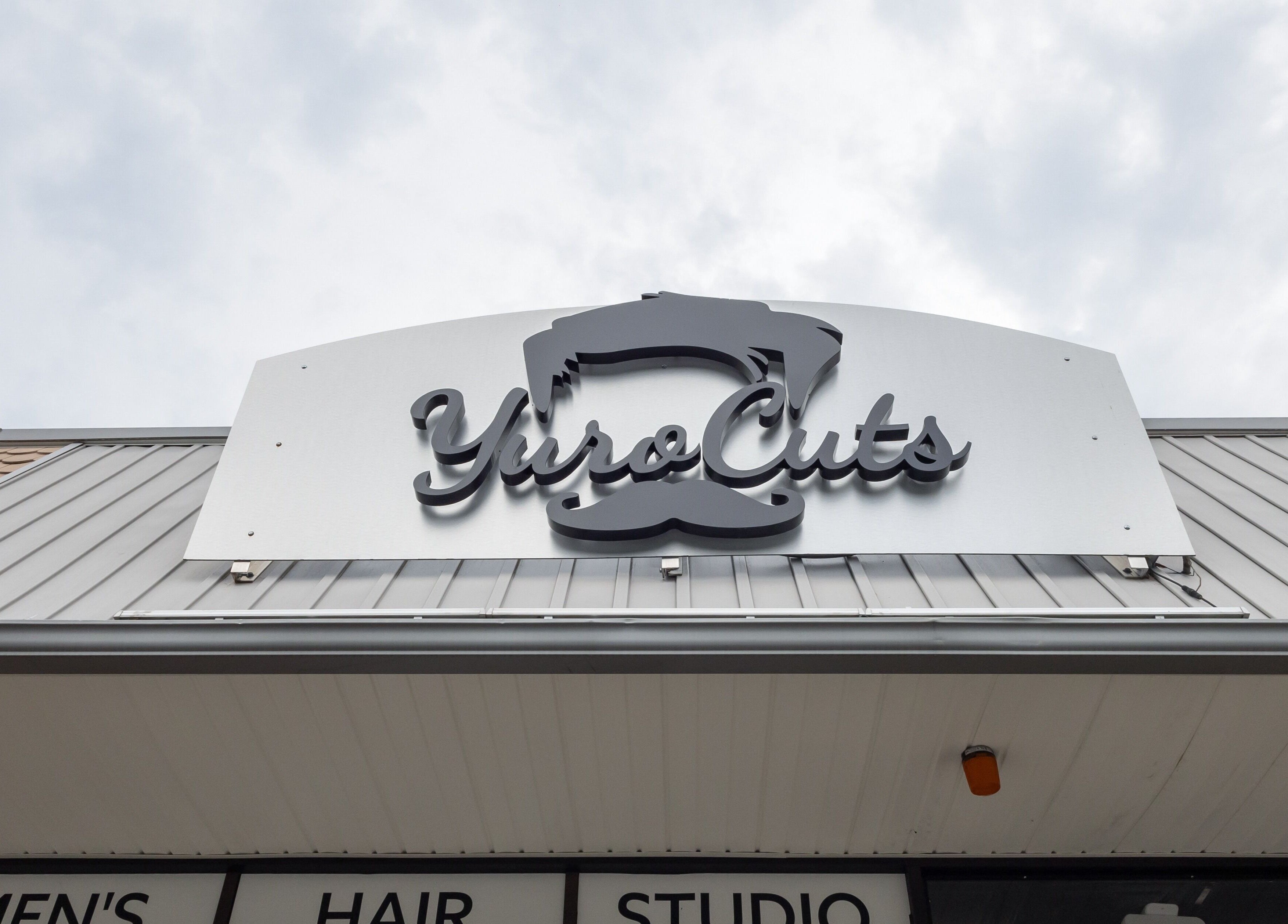 YuroCuts Garnerville exterior sign in Mount Ivy, New York, US, featuring bold modern logo design.