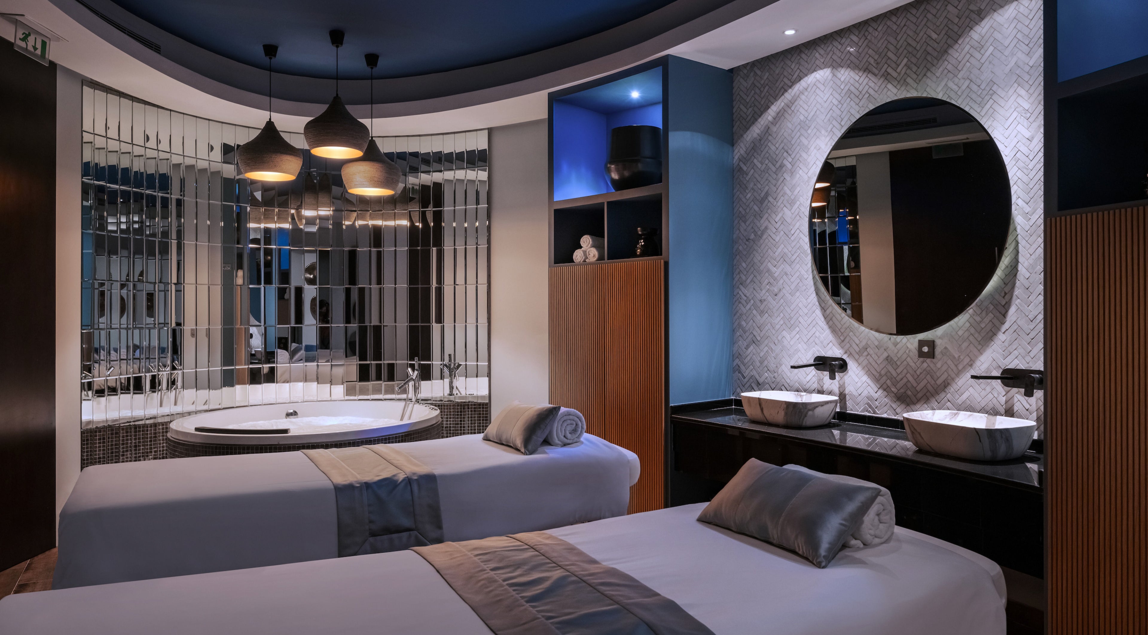 Luxury spa room at SENSASIA - Emirates Golf Club, Dubai, Dubai, AE, with double massage beds and a whirlpool tub.