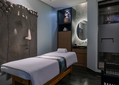 Relaxing spa room at SENSASIA - Emirates Golf Club, Dubai, Dubai, AE featuring a serene Buddha artwork.