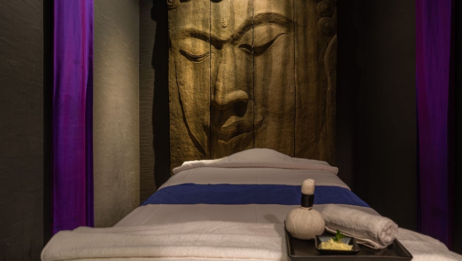 Tranquil massage bed at SENSASIA - The Village in Dubai, Dubai, AE, with a serene Buddha backdrop.