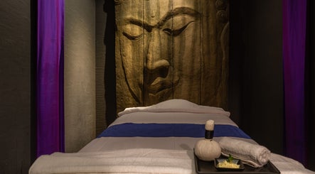 Tranquil massage bed at SENSASIA - The Village in Dubai, Dubai, AE, with a serene Buddha backdrop.