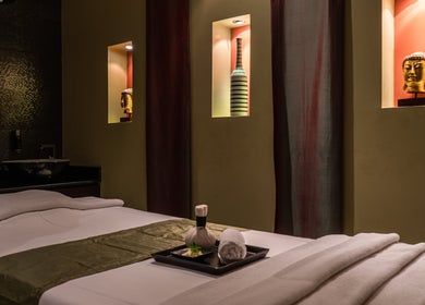 Relaxing spa room at SENSASIA - The Village, Dubai, Dubai, AE with calming decor and massage table.