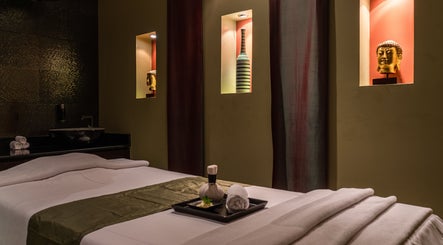Relaxing spa room at SENSASIA - The Village, Dubai, Dubai, AE with calming decor and massage table.