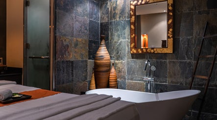 Luxurious spa room at SENSASIA - The Village, Dubai, Dubai, AE featuring a soaking tub and elegant decor.