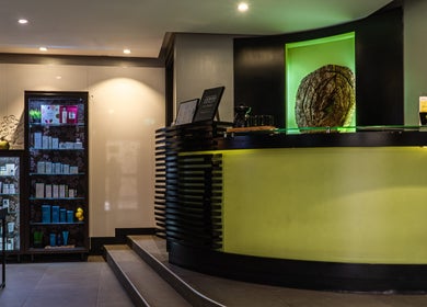 The welcoming reception at SENSASIA - The Village, featuring a stylish desk and product display in Dubai, Dubai, AE.