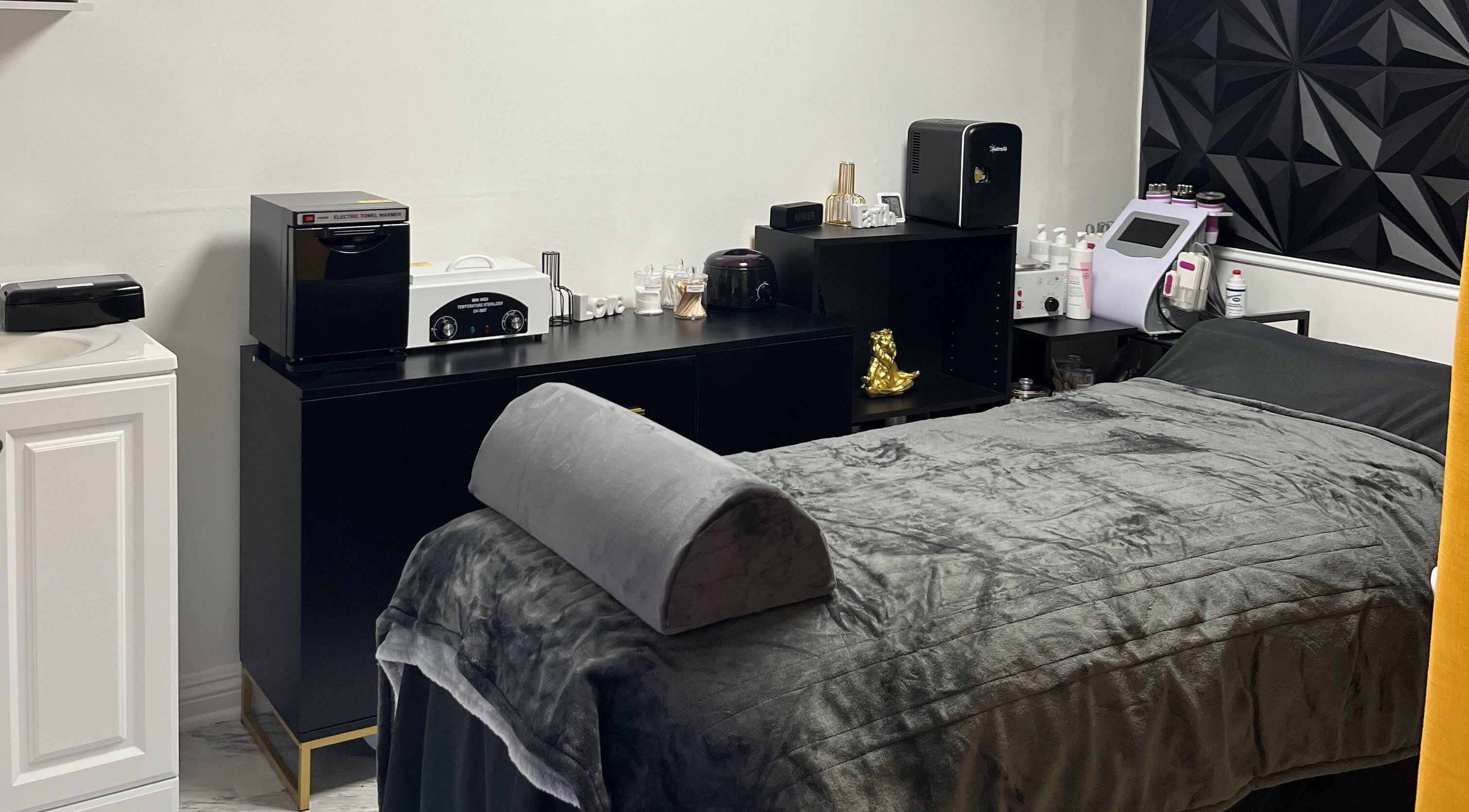 Modern treatment room at Niosha Body Bar in Torrance, California, US, featuring a plush therapy bed.