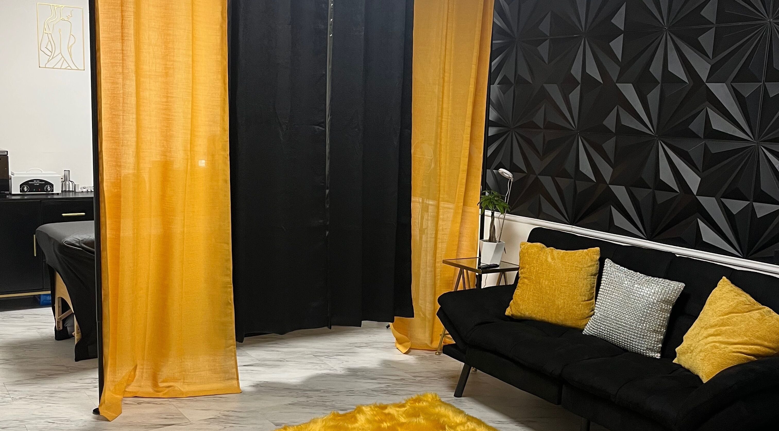 Elegant and cozy interior of Niosha Body Bar, Torrance, California, US with black and gold decor.