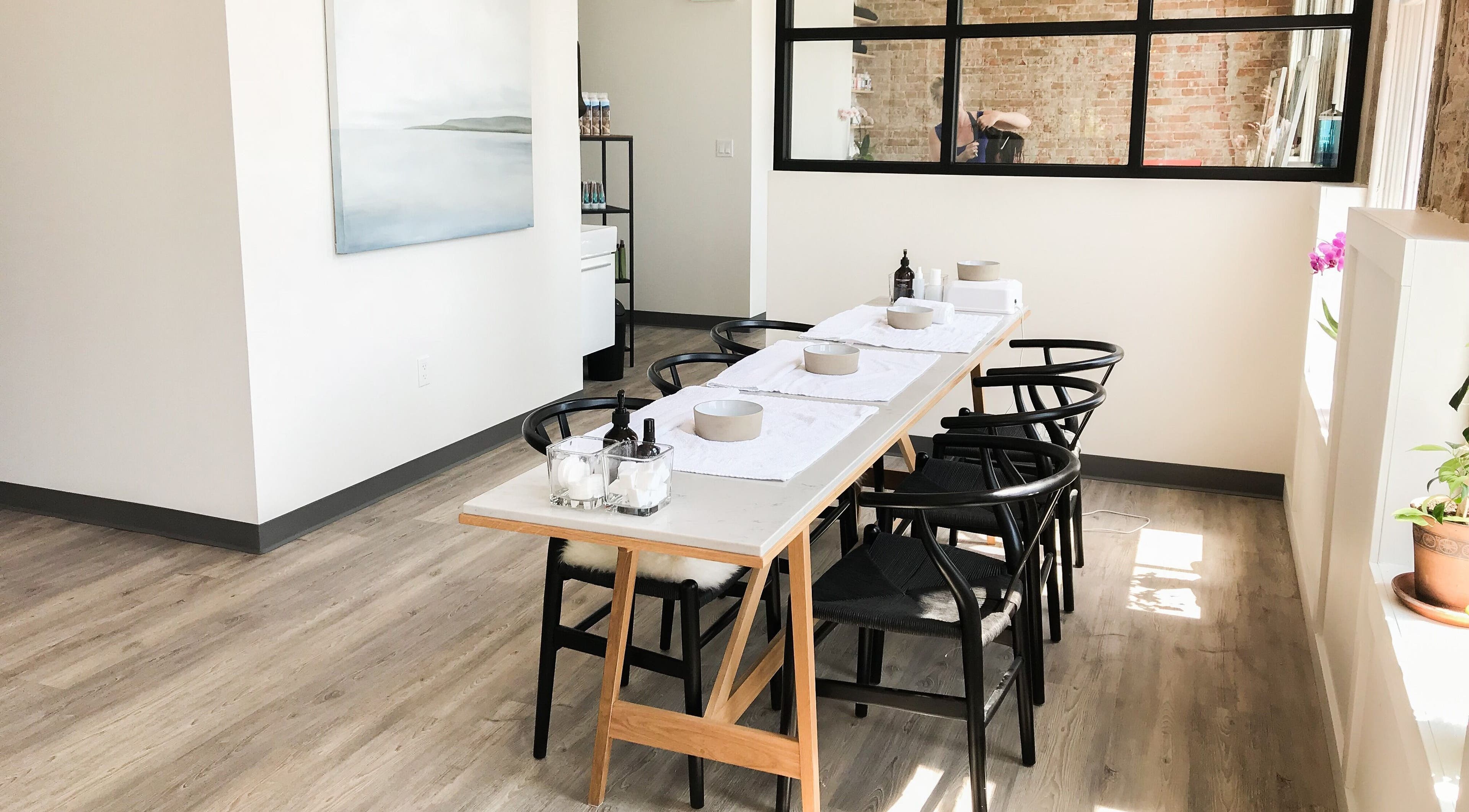 Elegant spa treatment table at The Refinery Spa + Social House in Kingston, Ontario, CA with natural lighting.